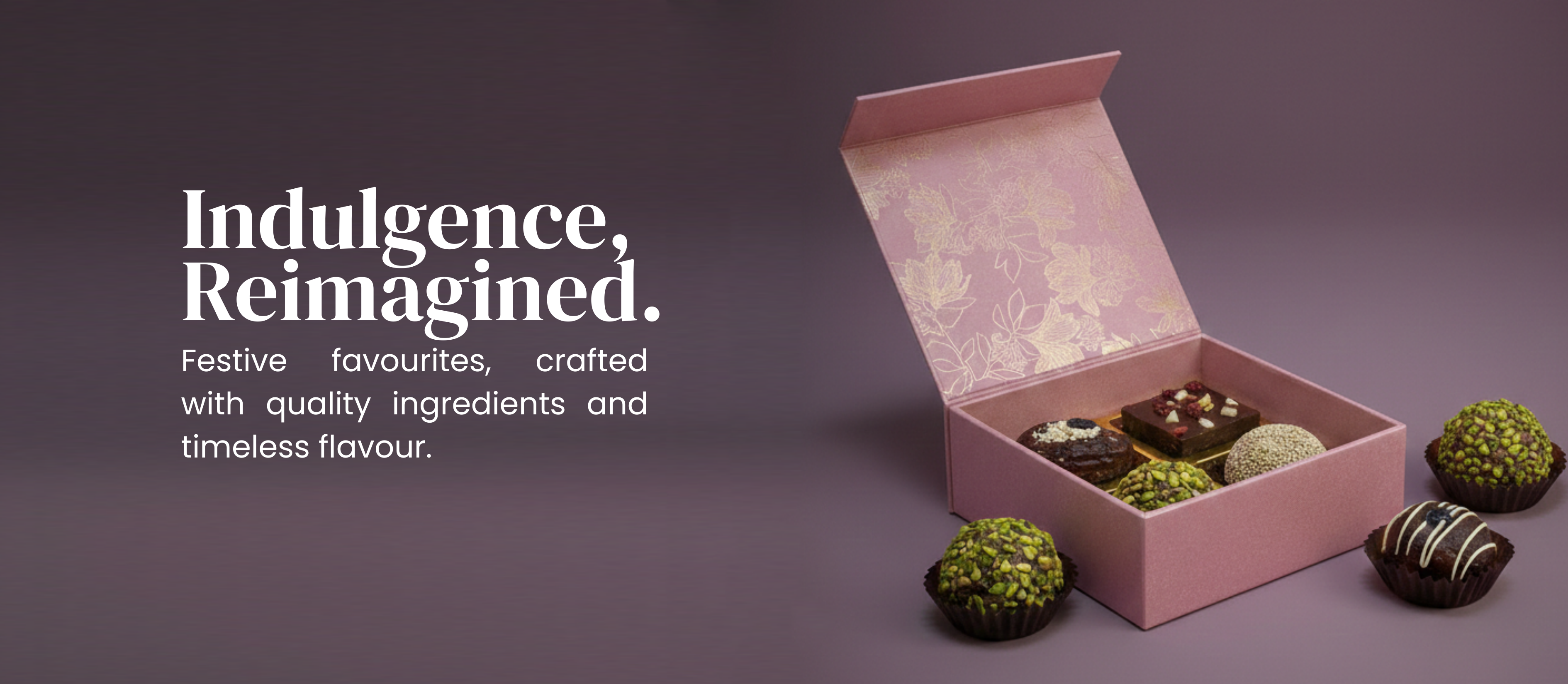 Open pink box with green and white decorated mithai, laddoo, all gluten free, on a purple background, featuring text 'Indulgence, Reimagined.' 